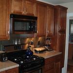 Galley kitchen redo - Maple cabinets and stainless steel backsplash